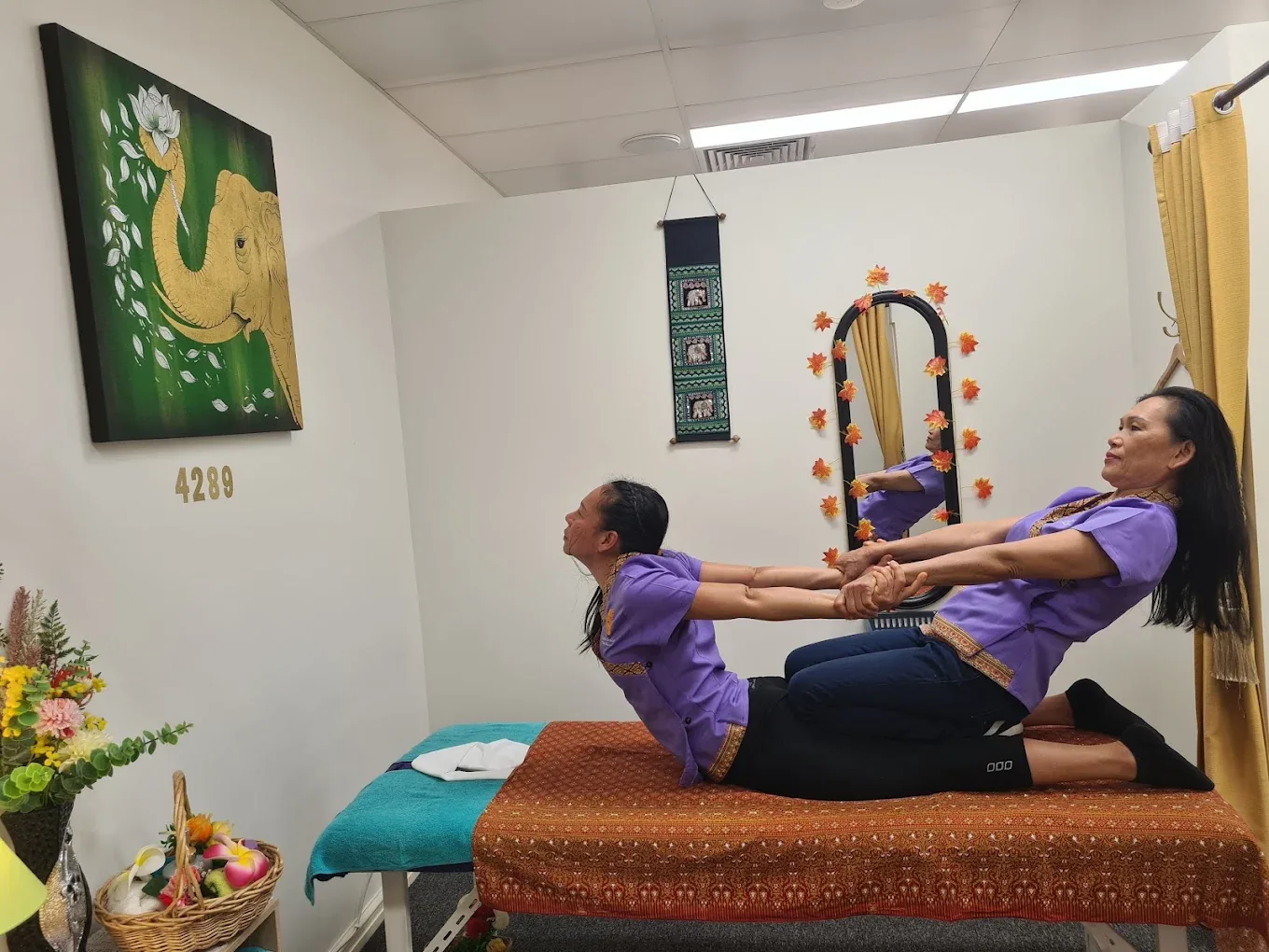 Therapist performing a traditional Thai stretch